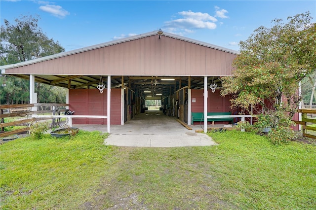 view of parking featuring an exterior structure and a carport