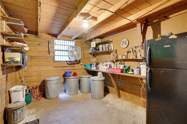 interior space with a workshop area, wood walls, wooden ceiling, and freestanding refrigerator