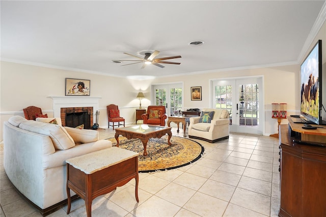 living area featuring french doors, visible vents, ornamental molding, and light tile patterned flooring