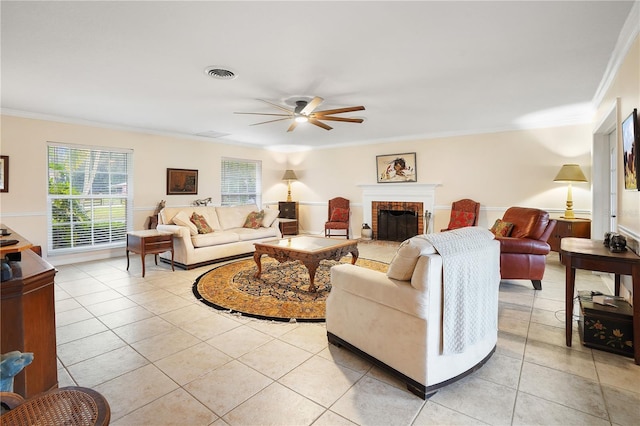 living room with light tile patterned floors, visible vents, a brick fireplace, and ornamental molding