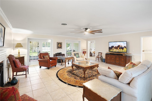 living room with light tile patterned floors, visible vents, ornamental molding, and a fireplace