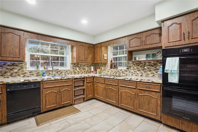 kitchen featuring open shelves, a sink, black appliances, light countertops, and backsplash