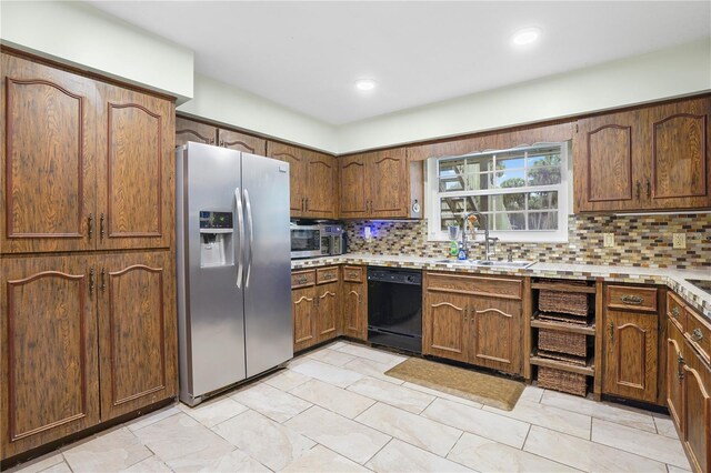 kitchen featuring light countertops, tasteful backsplash, appliances with stainless steel finishes, and a sink