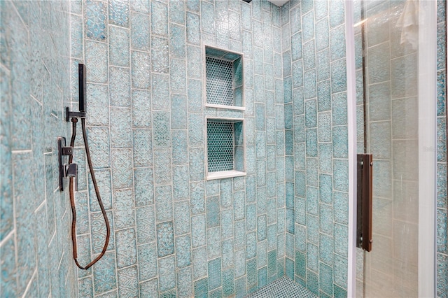 bathroom with tiled shower