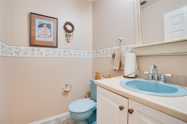 bathroom featuring vanity, toilet, and visible vents