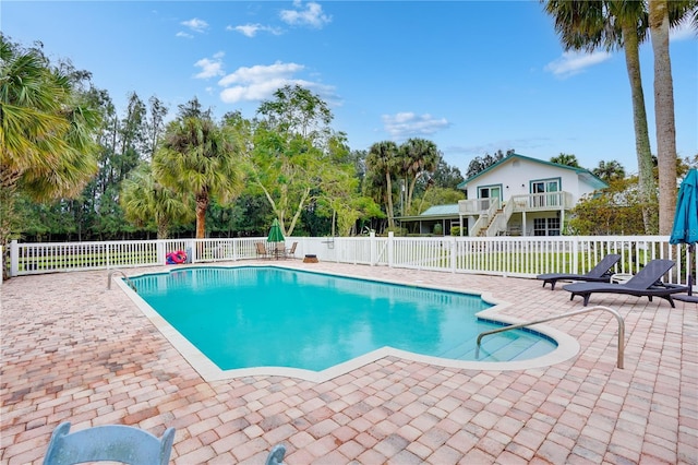 view of pool featuring a patio, a fenced in pool, and fence