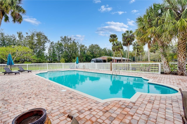 view of swimming pool with a fenced in pool, a patio, and fence