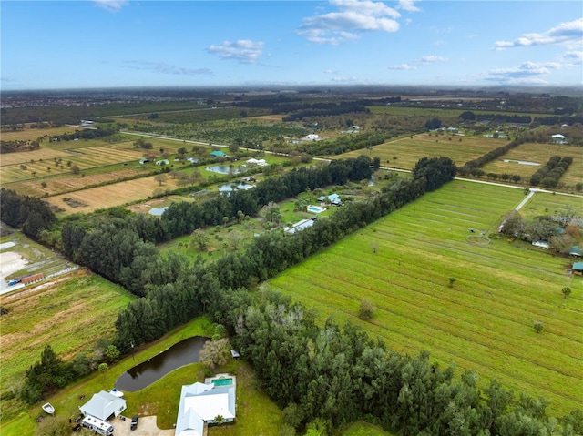 birds eye view of property with a rural view and a water view