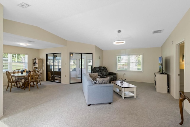 living room with visible vents, light carpet, and lofted ceiling