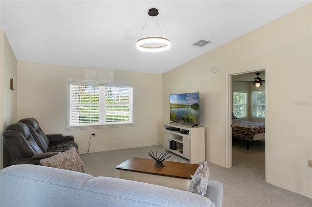 living room with vaulted ceiling, baseboards, visible vents, and light carpet