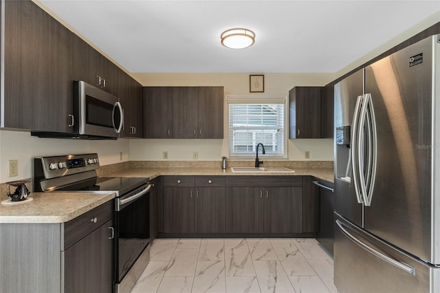 kitchen featuring a sink, stainless steel appliances, dark brown cabinetry, light countertops, and marble finish floor