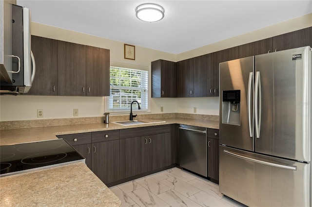 kitchen featuring a sink, dark brown cabinets, marble finish floor, and stainless steel appliances