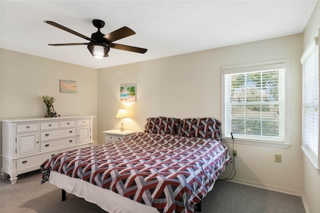 carpeted bedroom featuring ceiling fan and baseboards