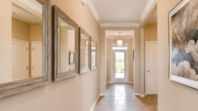 entryway featuring baseboards, crown molding, and light tile patterned flooring