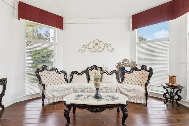 sitting room with lofted ceiling, crown molding, a healthy amount of sunlight, and wood-type flooring