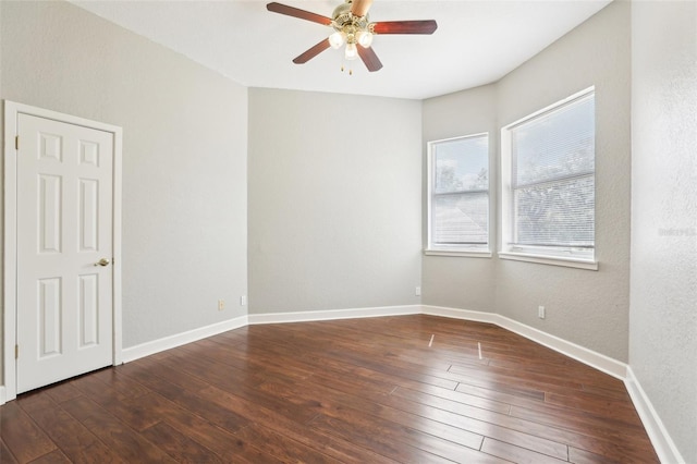 unfurnished room with baseboards, a ceiling fan, and hardwood / wood-style flooring