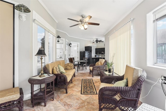 living room with plenty of natural light, ceiling fan, and ornamental molding