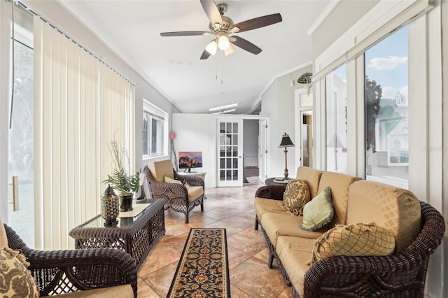 living area featuring ceiling fan, lofted ceiling, ornamental molding, light tile patterned floors, and french doors