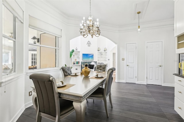 dining space featuring a chandelier, arched walkways, dark wood-type flooring, and ornamental molding