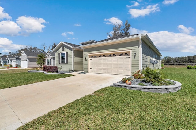 single story home with a front lawn, a garage, and driveway