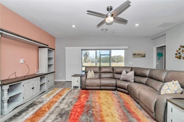 living area with a ceiling fan, recessed lighting, wood finished floors, and visible vents