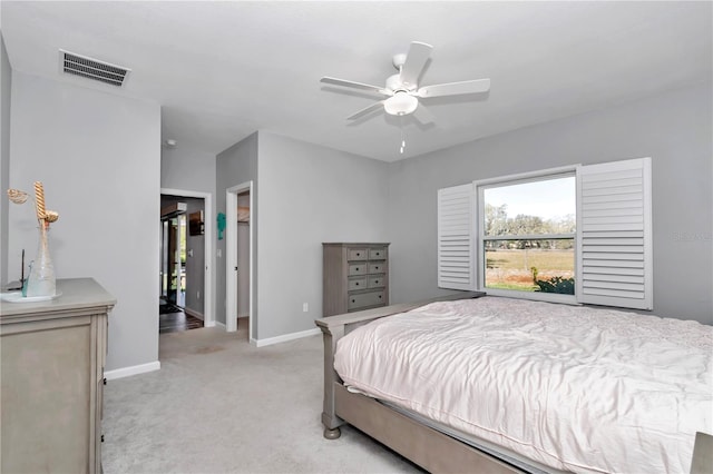 bedroom with a ceiling fan, baseboards, visible vents, and light carpet