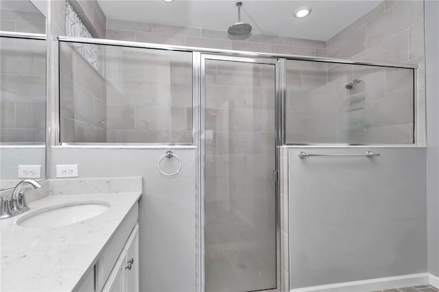 full bathroom with a stall shower and vanity