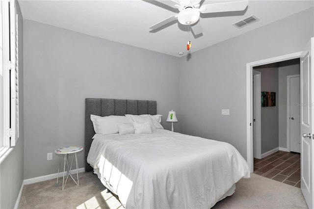 bedroom featuring baseboards, visible vents, and ceiling fan