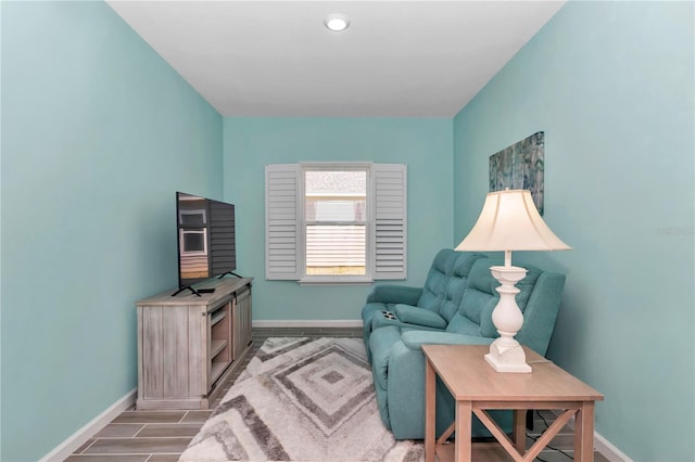 sitting room featuring baseboards and wood finish floors