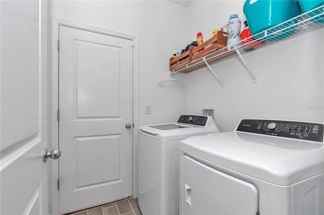 washroom featuring laundry area, independent washer and dryer, and wood finished floors