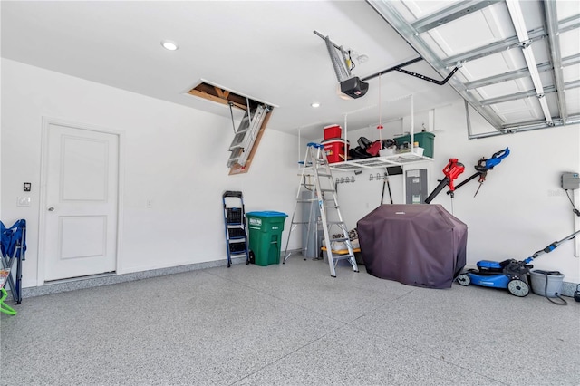 garage featuring electric panel, recessed lighting, and a garage door opener