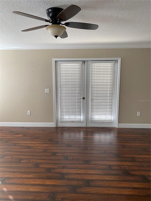 empty room with a textured ceiling, ornamental molding, and wood finished floors