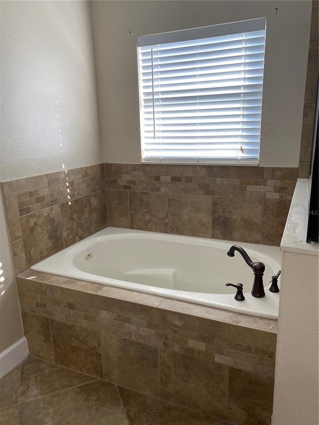 full bathroom with tile patterned flooring and a garden tub