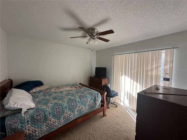 bedroom featuring a textured ceiling, carpet, and a ceiling fan