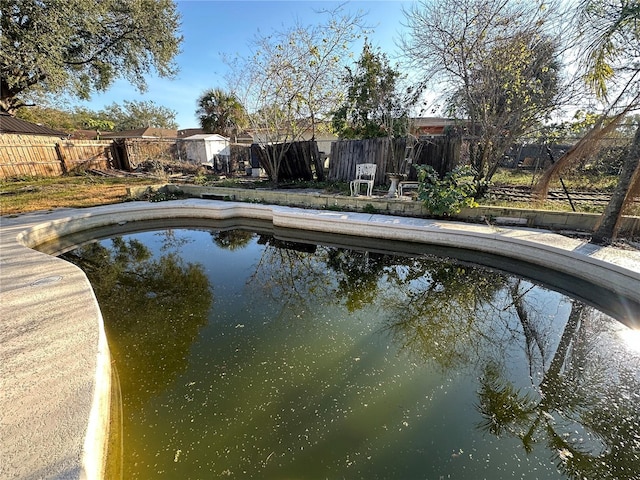 view of swimming pool with a fenced backyard