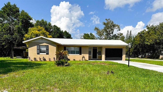 ranch-style home with a front yard, concrete driveway, an attached garage, and stucco siding