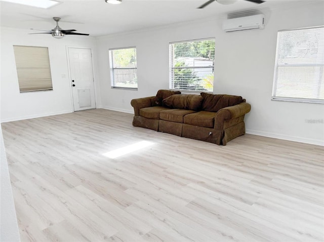 living room with baseboards, ceiling fan, ornamental molding, wood finished floors, and a wall mounted air conditioner