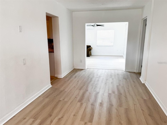 interior space featuring light wood-style flooring and baseboards