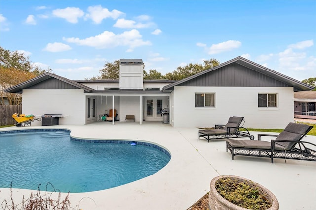 view of swimming pool featuring a fenced in pool, french doors, a patio, area for grilling, and fence