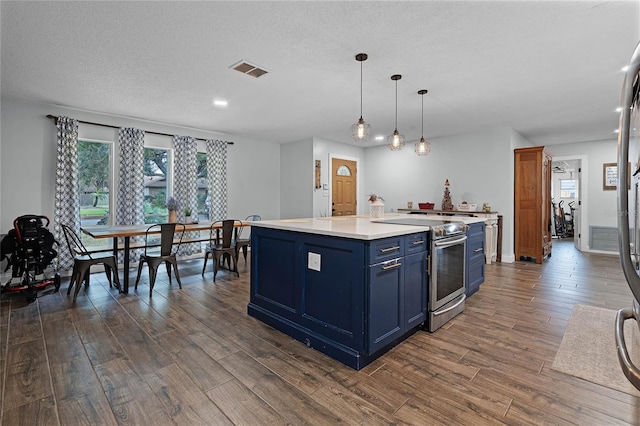 kitchen with blue cabinets, visible vents, stainless steel electric range, and dark wood-style floors