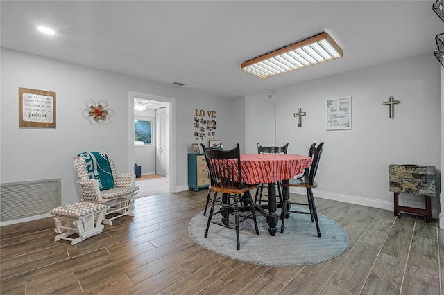 dining space featuring baseboards, visible vents, and wood finished floors