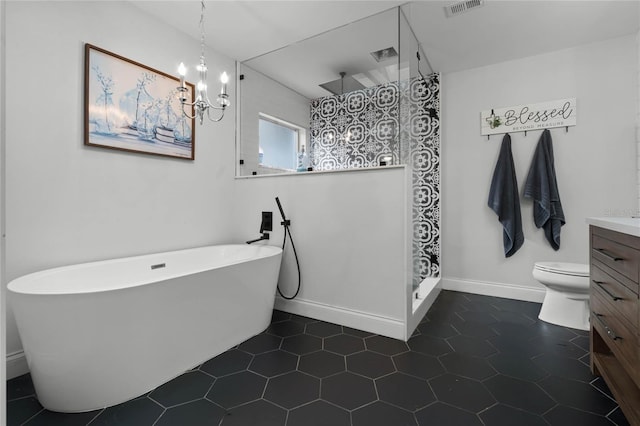 bathroom with a walk in shower, a freestanding tub, visible vents, vanity, and baseboards