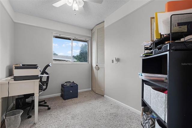 office with a ceiling fan, carpet, a textured ceiling, and baseboards