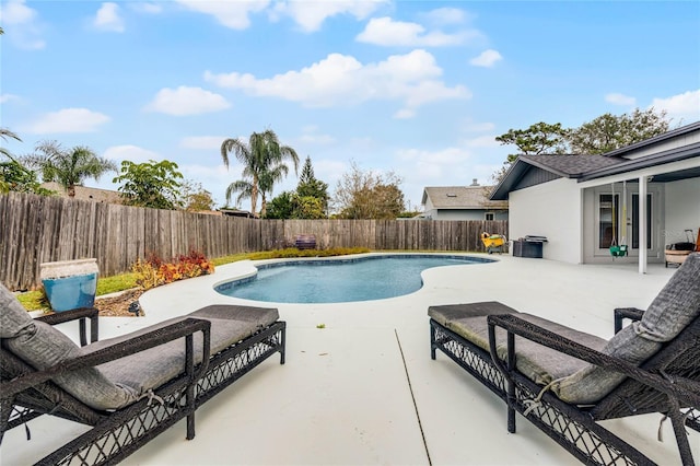 view of swimming pool with a patio area, a fenced backyard, a fenced in pool, and french doors