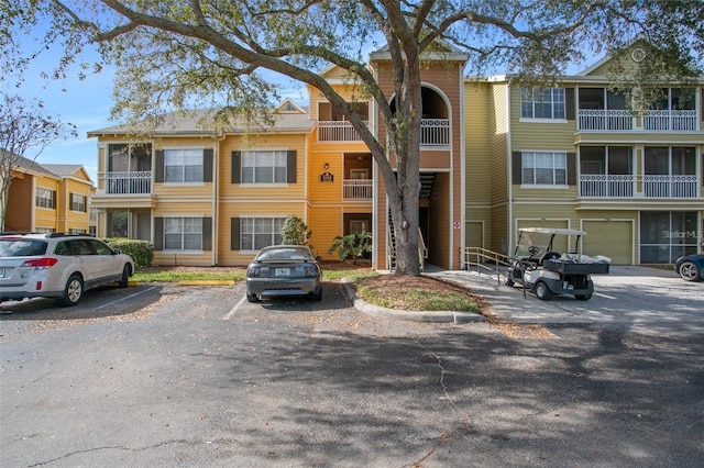 view of building exterior featuring uncovered parking