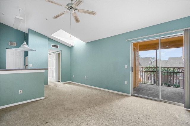 spare room with ceiling fan, carpet, a skylight, and baseboards