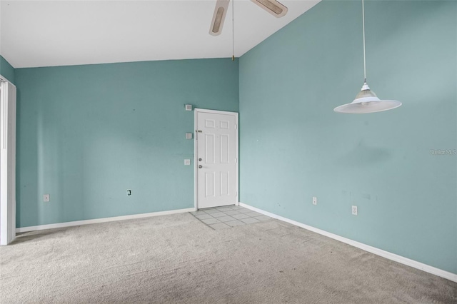 empty room with high vaulted ceiling, baseboards, a ceiling fan, and carpet flooring