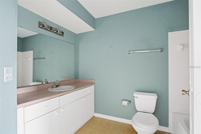 bathroom with toilet, baseboards, and vanity