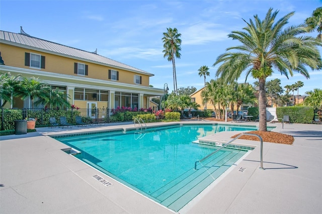 pool featuring a patio and fence