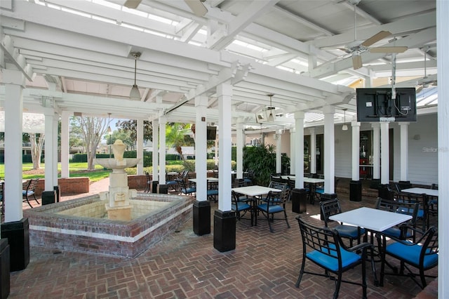 interior space featuring ceiling fan and decorative columns